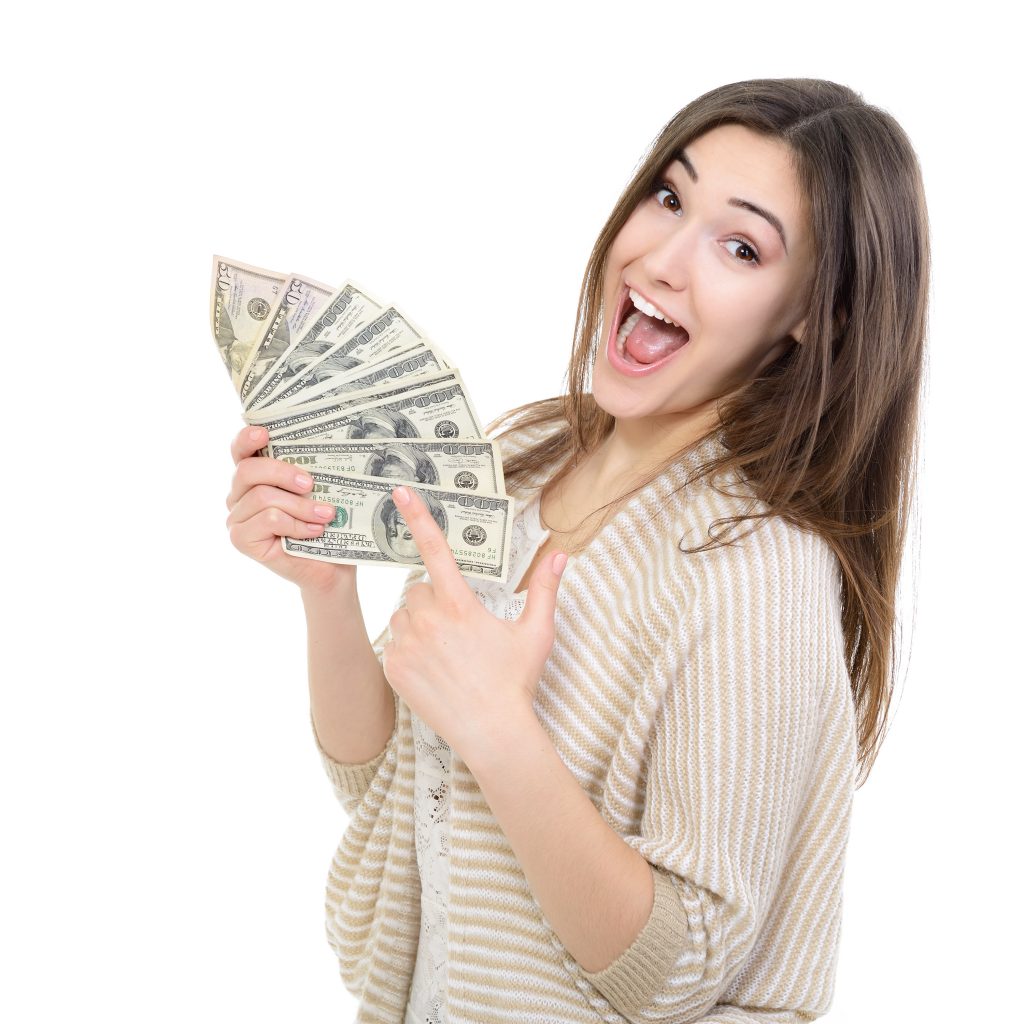 Cheerful attractive young lady holding cash and happy smiling over white background