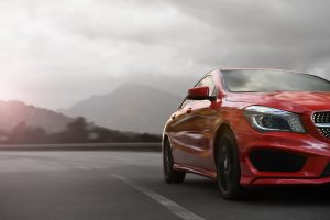 Red sports car travels down a misty highway after getting title loans in Stowe