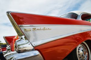 The tail fin of a cherry-red Bel Air.